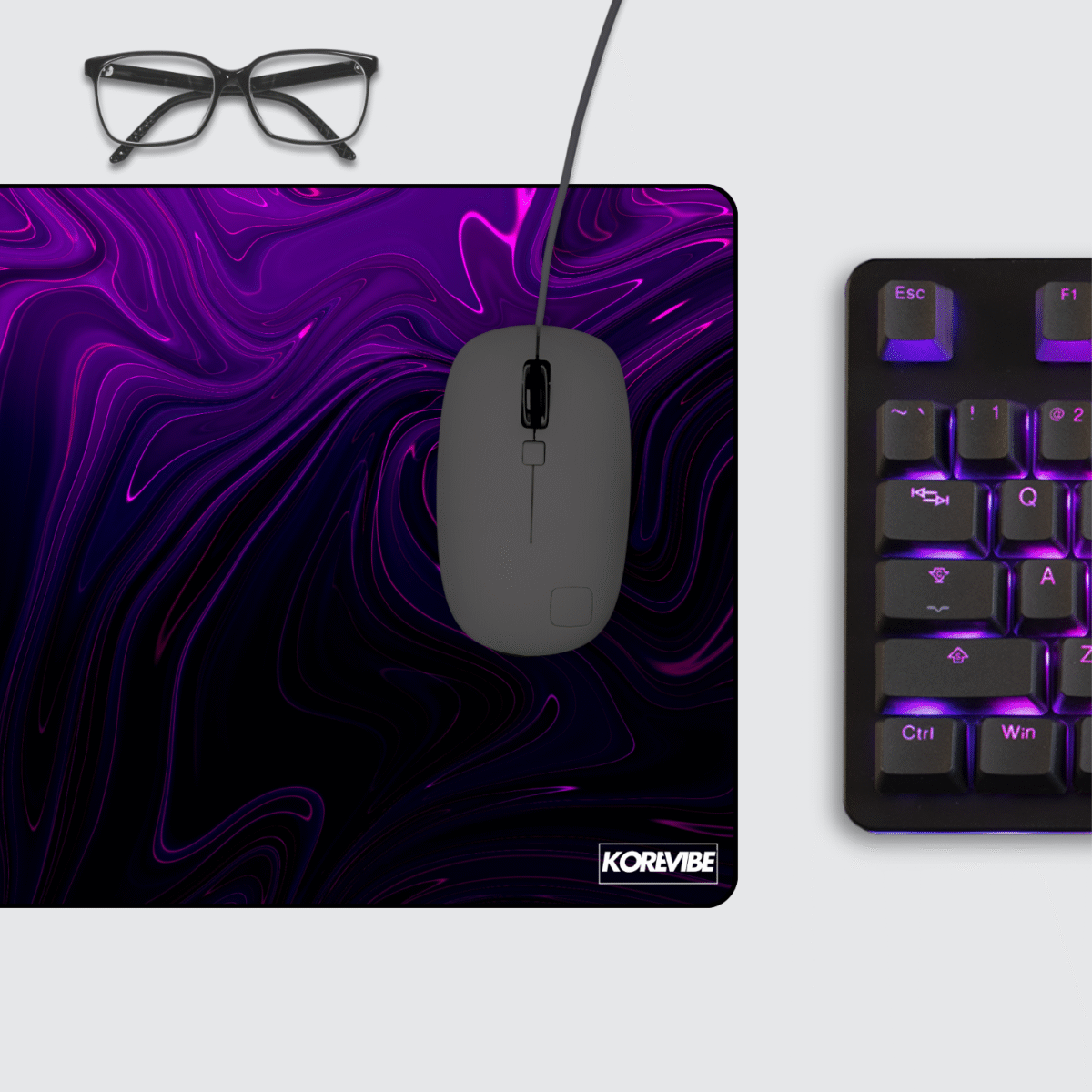 Abstract Liquid Purple Gaming Mouse Pad on desk – neon purple abstract fluid design