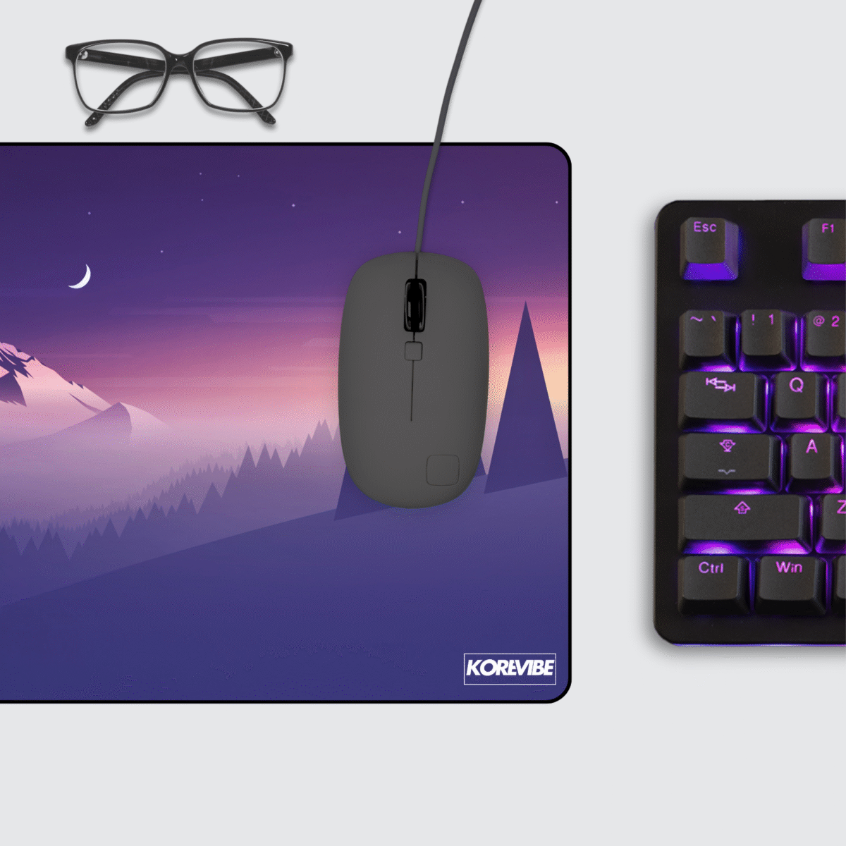 Minimalist gaming mouse pad on desk setup with keyboard and mouse – retro synthwave purple mountain art aesthetic.