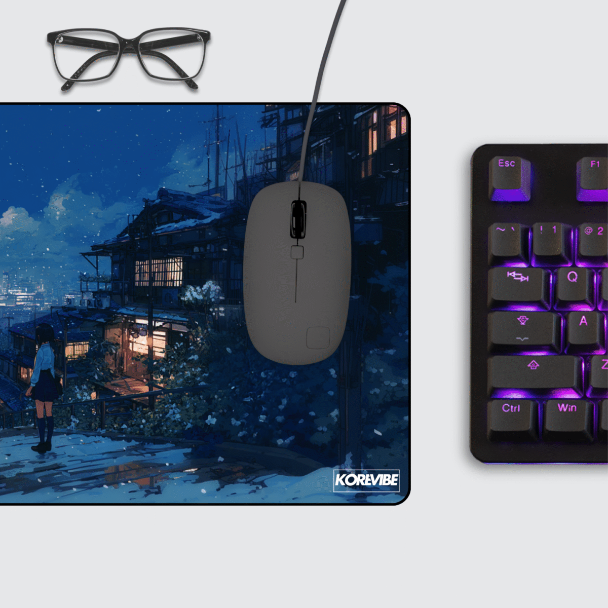 Snowy Night Cityscape gaming mouse pad on desk with keyboard and mouse – winter cityscape aesthetic for gamers.
